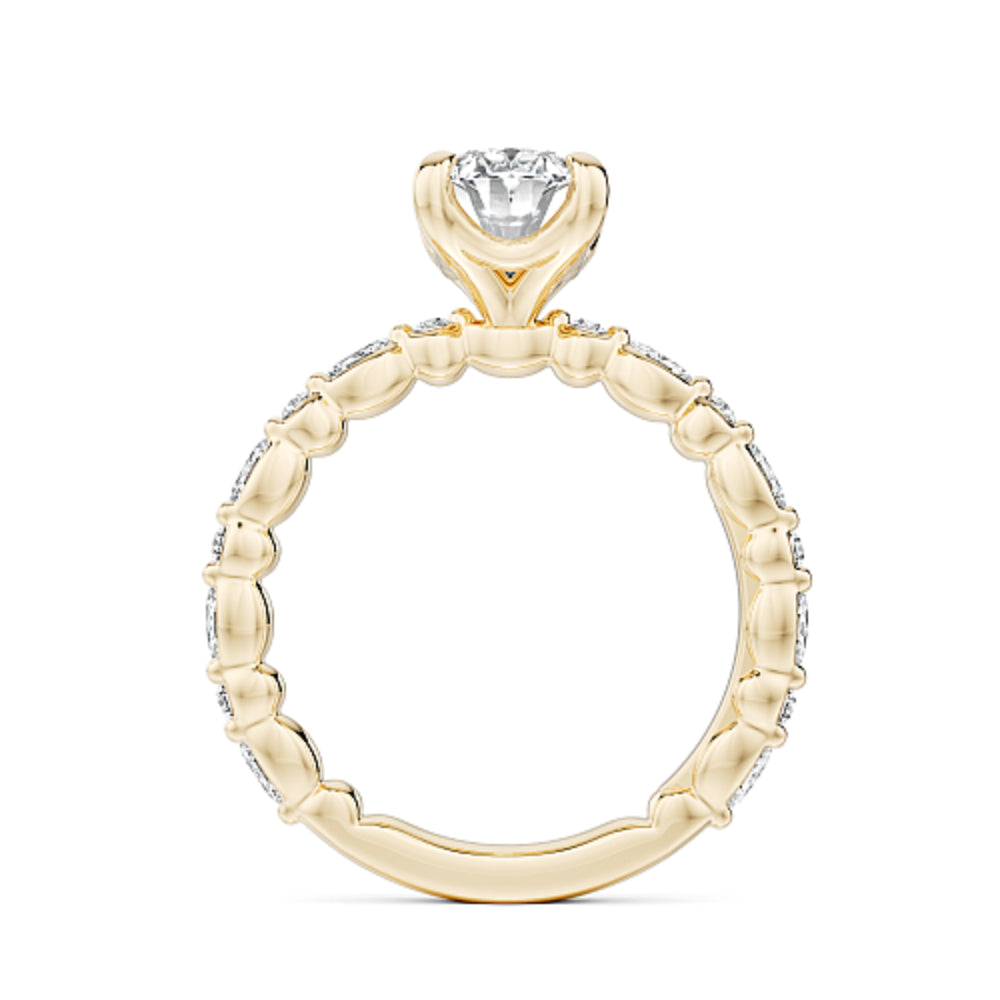 Gold Noam Carver ring with a large oval diamond center and smaller round/marquise diamond sides on a white background