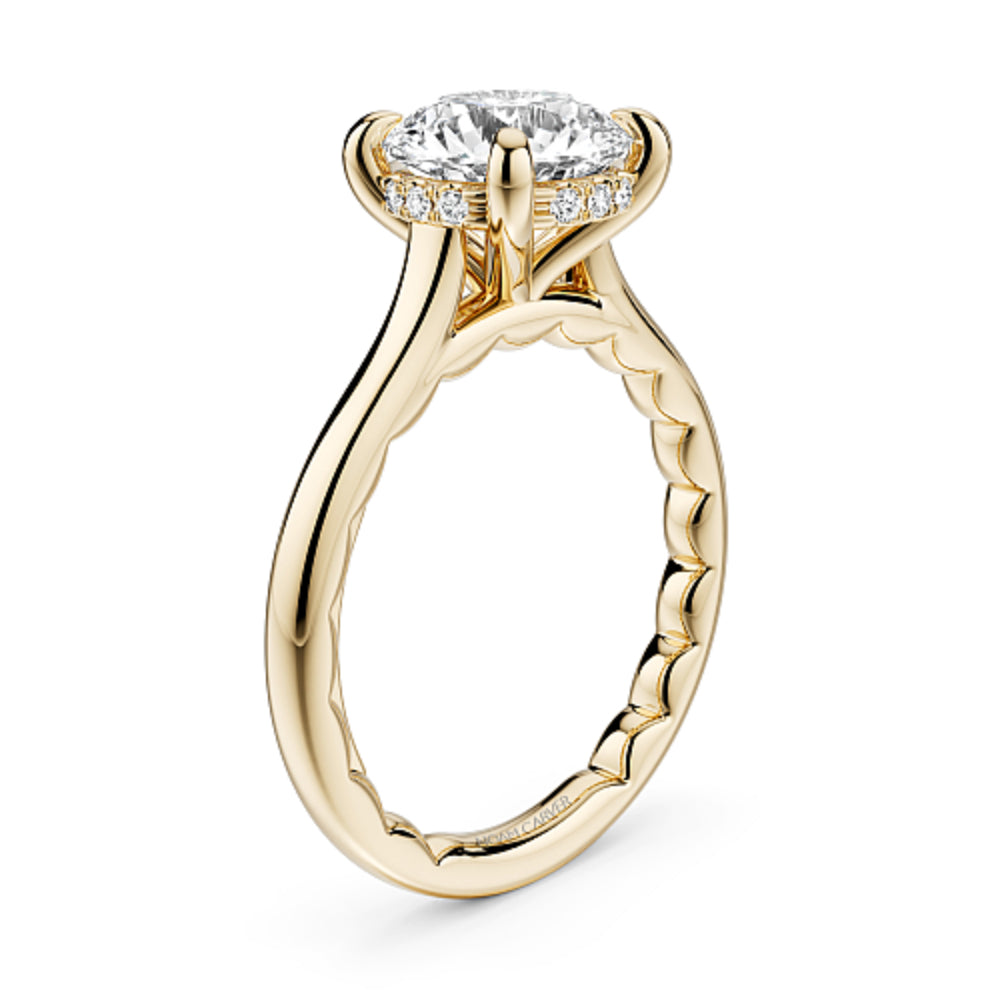 Gold Noam Carver ring with a large Round diamond center and round diamond hidden halo on a white background