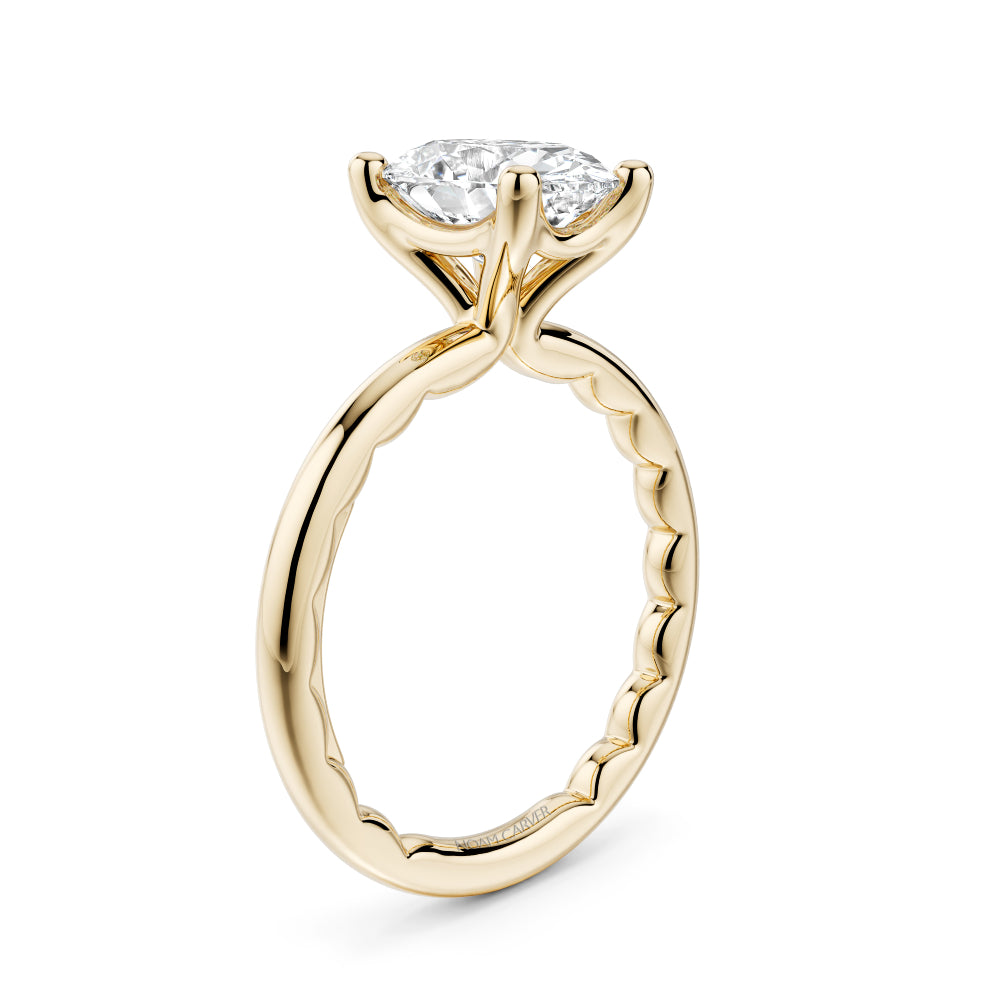 Gold Noam Carver ring with a large Oval diamond on a white background