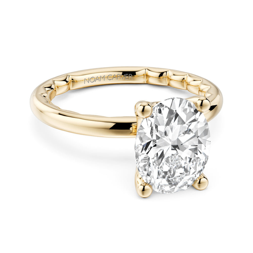 Gold Noam Carver ring with a large Oval diamond on a white background