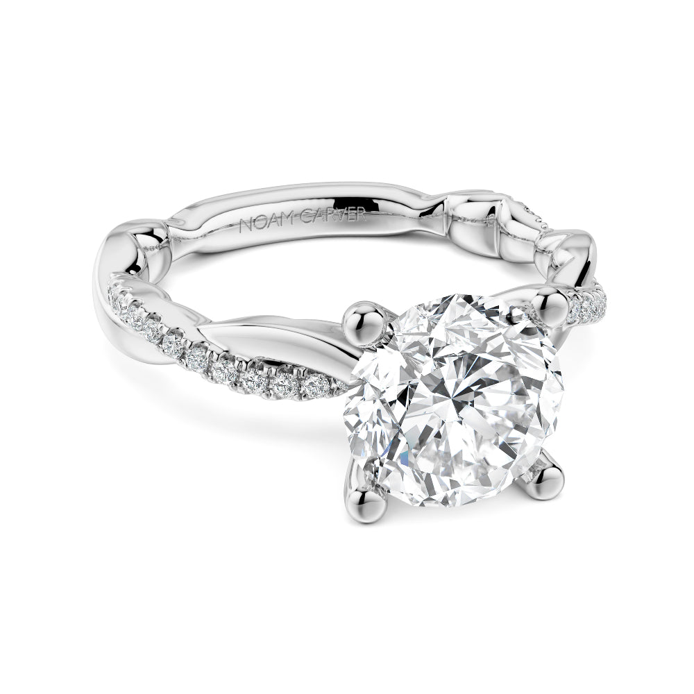 Diamond white gold Noam Carver ring with intricate twist design on a white background