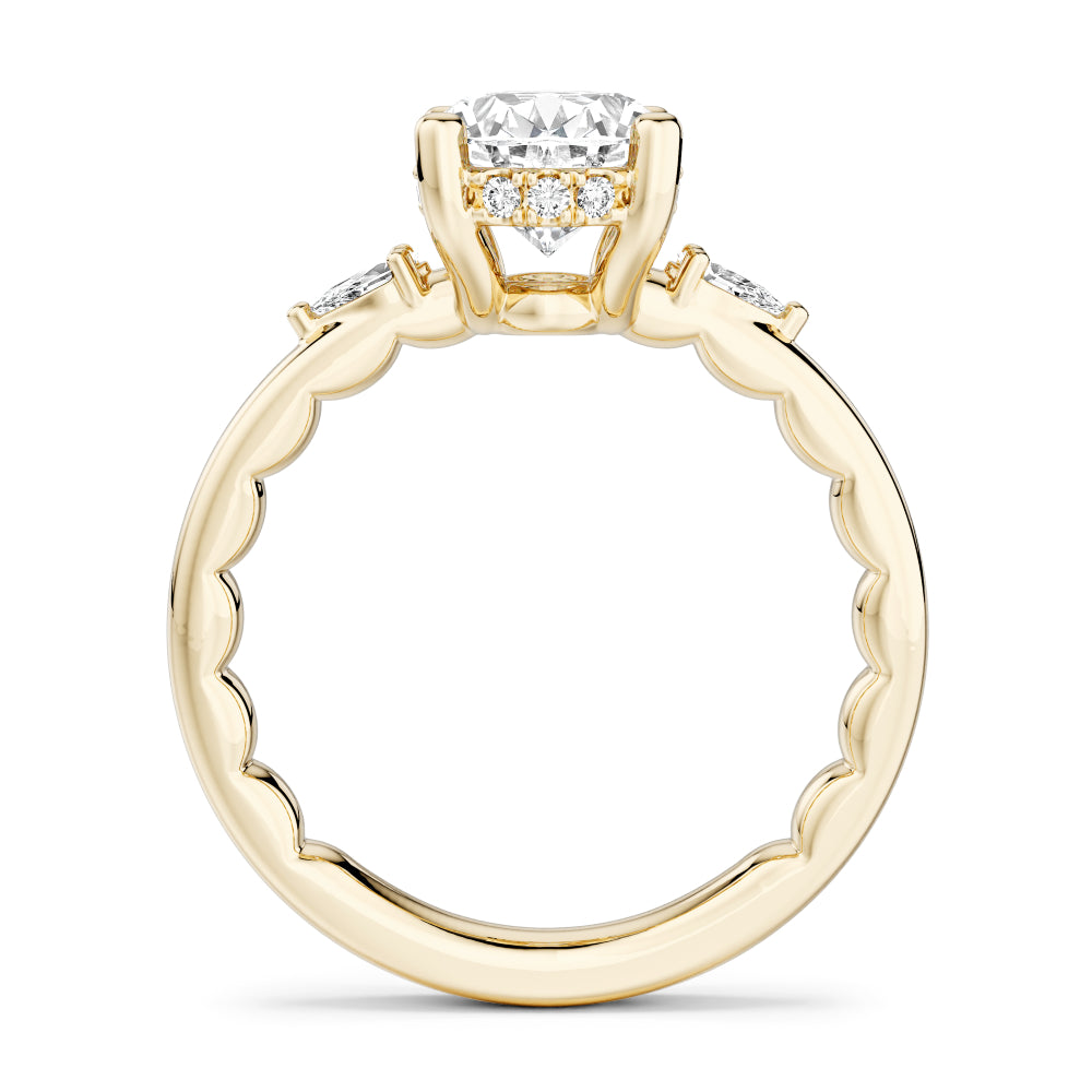 Gold Noam Carver ring with a large oval diamond center and smaller pear shape diamond sides on a white background