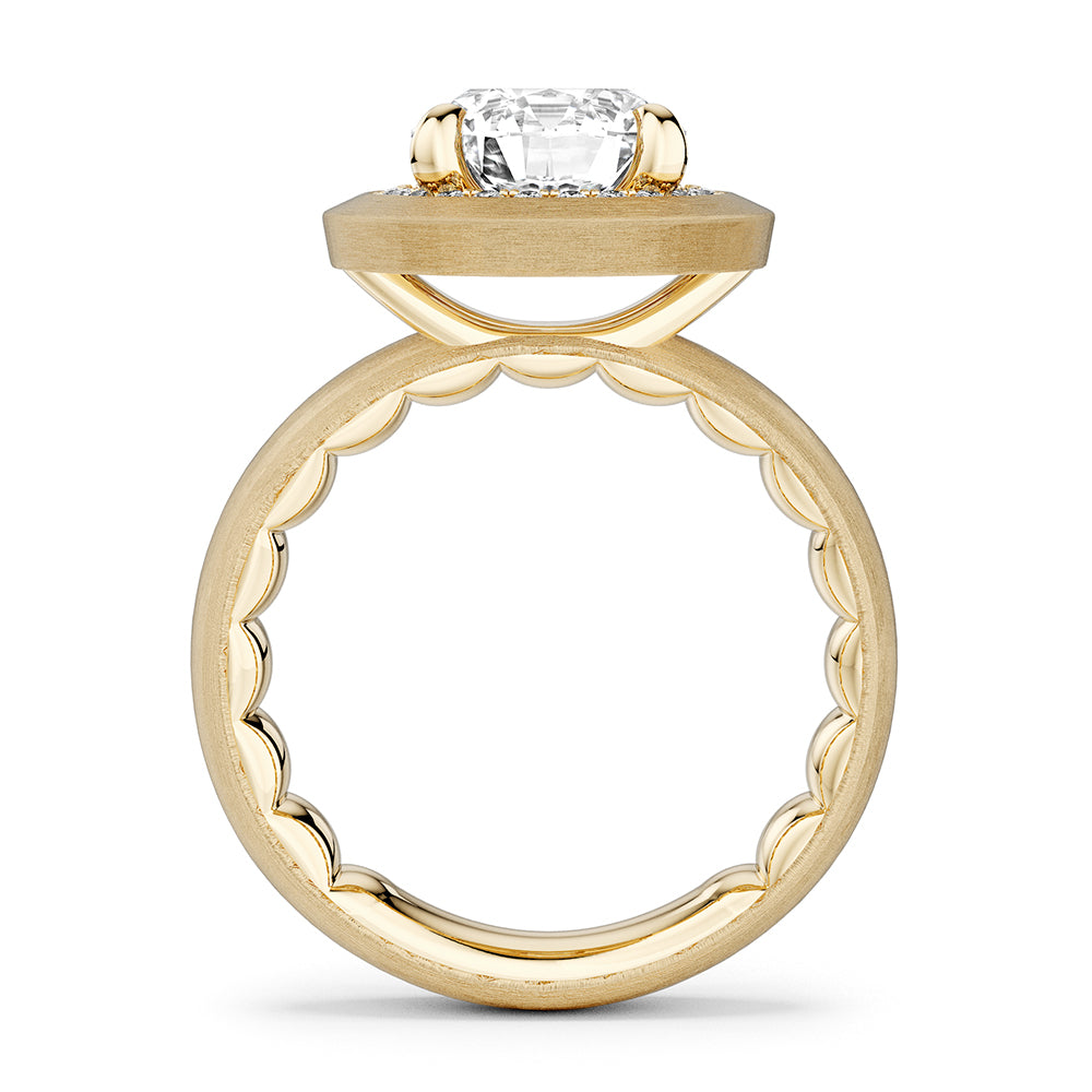 Brushed gold Noam Carver ring with a large diamond and smaller surrounding diamonds on a white background