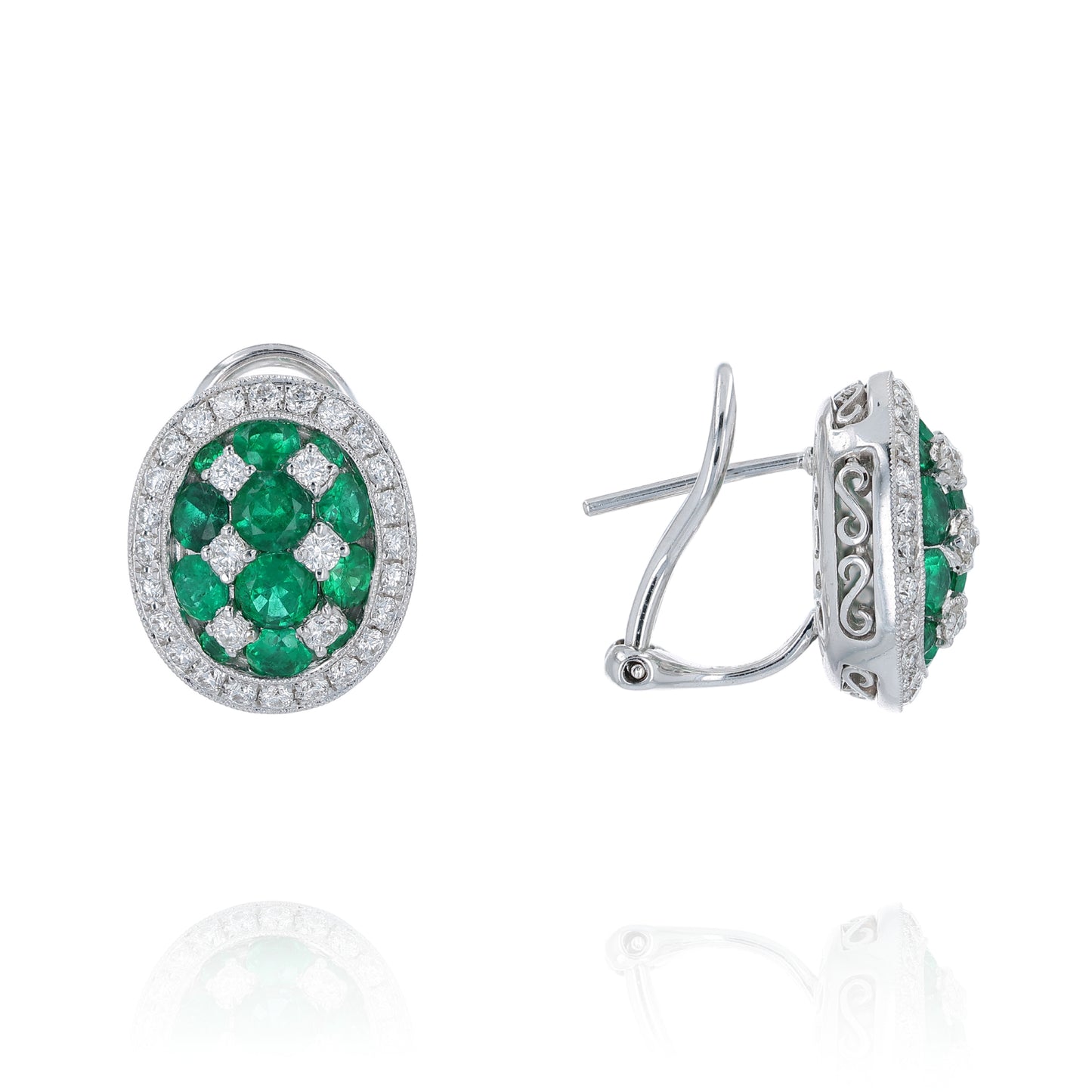 Pair of white gold emerald and diamond halo stud earrings on a white background