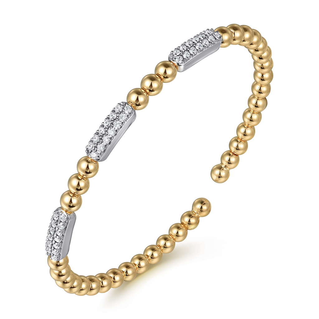 gold beaded bangle with clear stones on white background