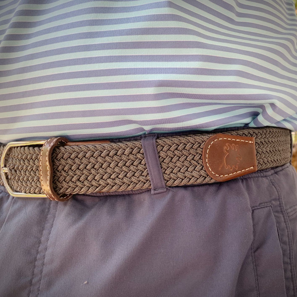 person wearing gray woven belt outdoors. 