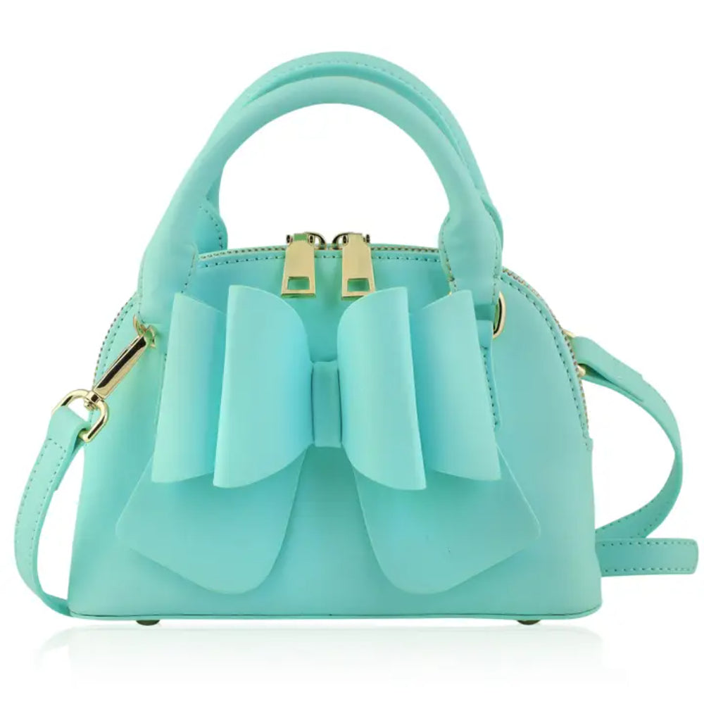 blue handbag with a large bow on a white background