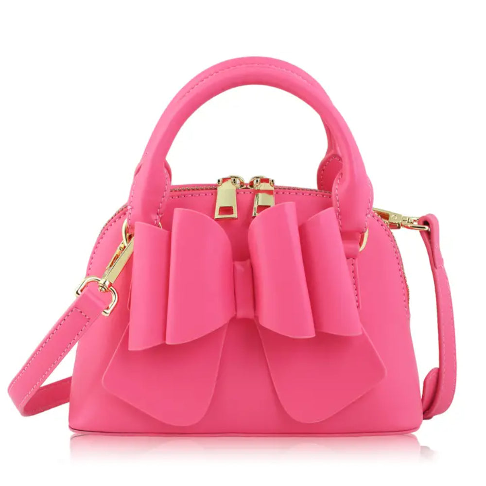 Pink handbag with a large bow on a white background