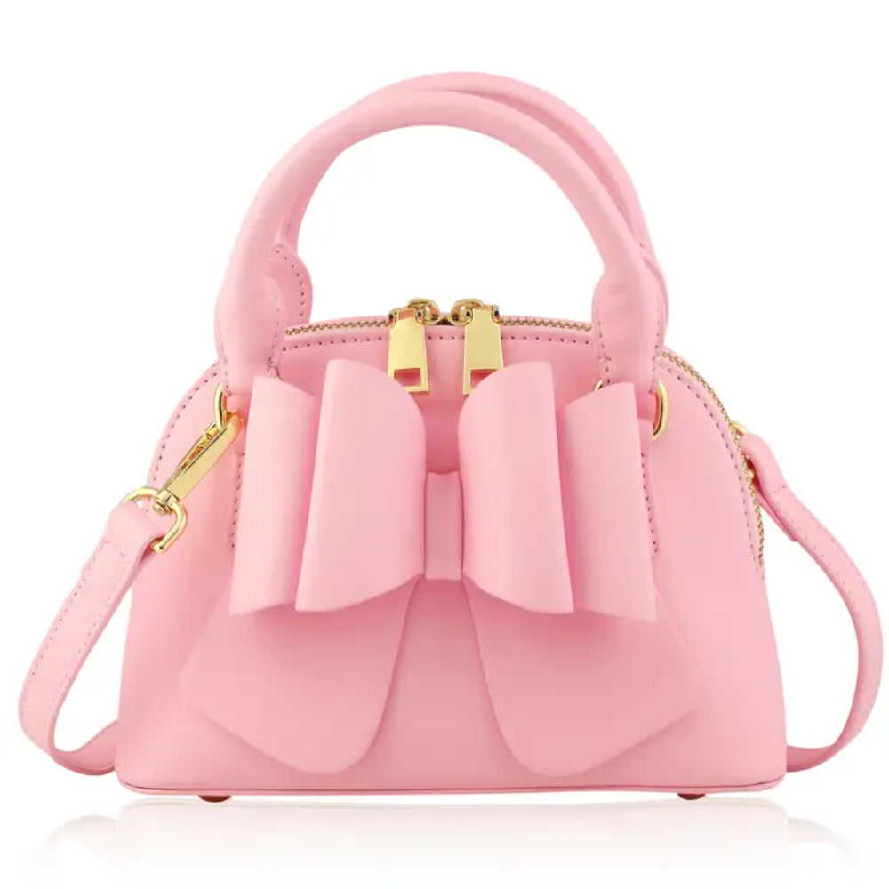 Light Pink handbag with a large bow on a white background