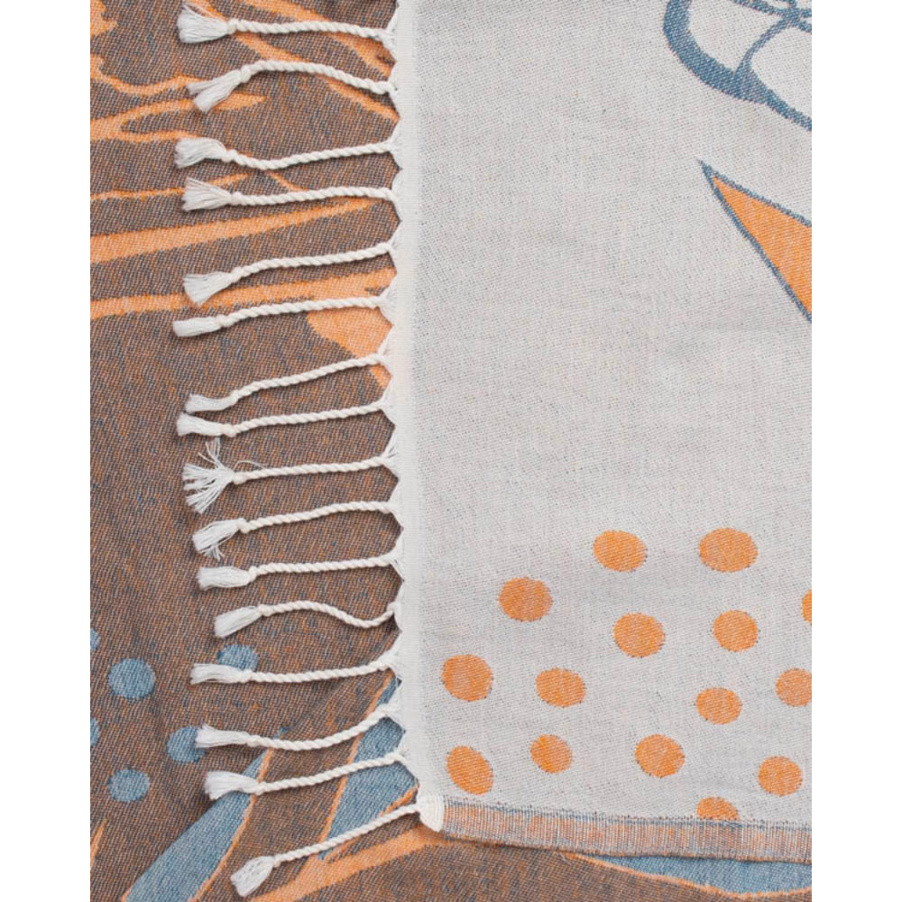 A close uo photo of a orange, blue and brown beach towel with parrot and leaf design and a white tassel edge white on a white background.