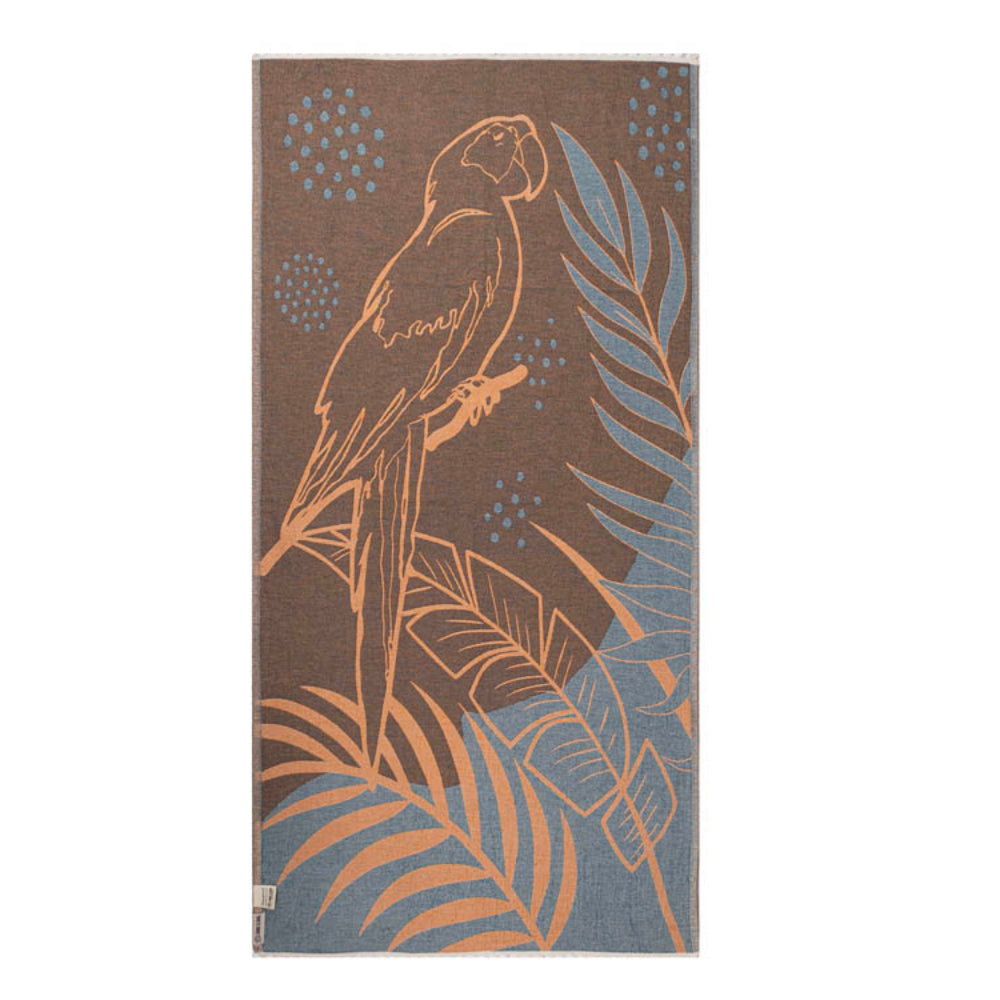 Side one of a orange, blue and brown beach towel with parrot and leaf design and a white tassel edge white on a white background.