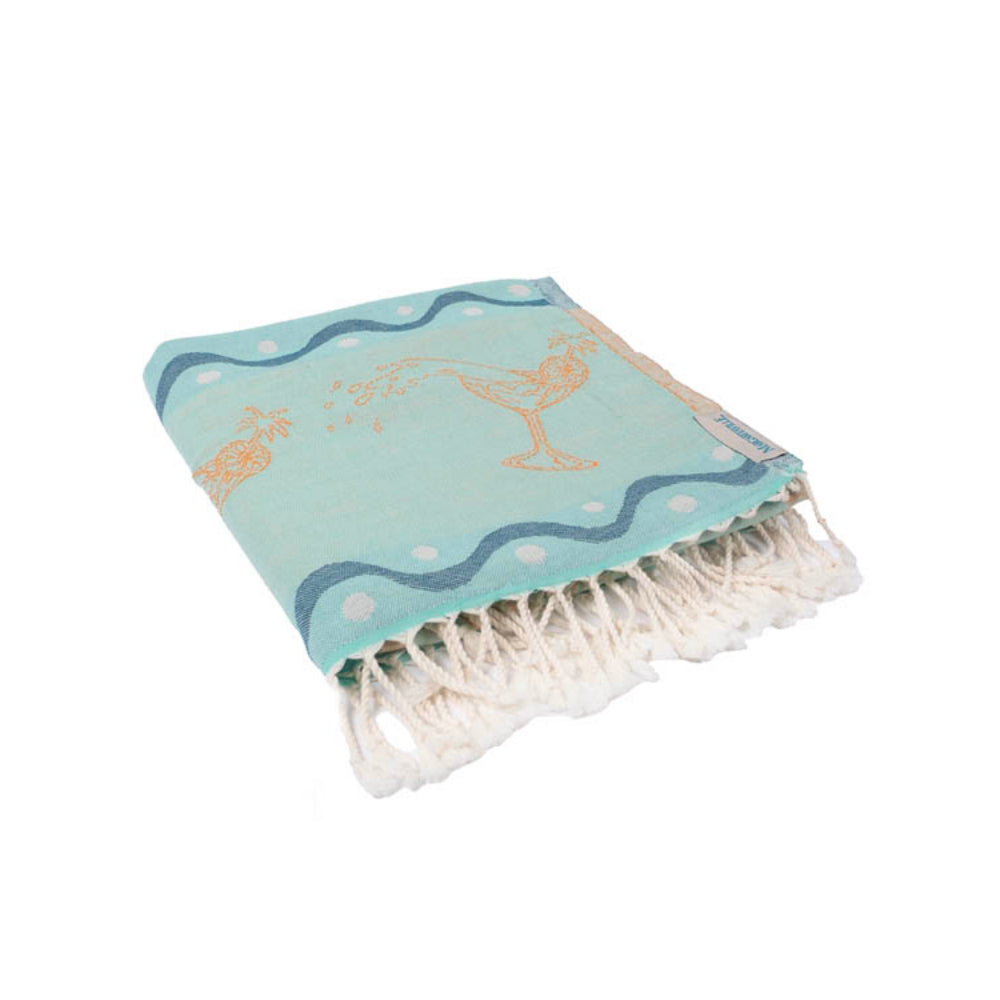 Turquoise beach towel with white polka dots and fringe on a white background.