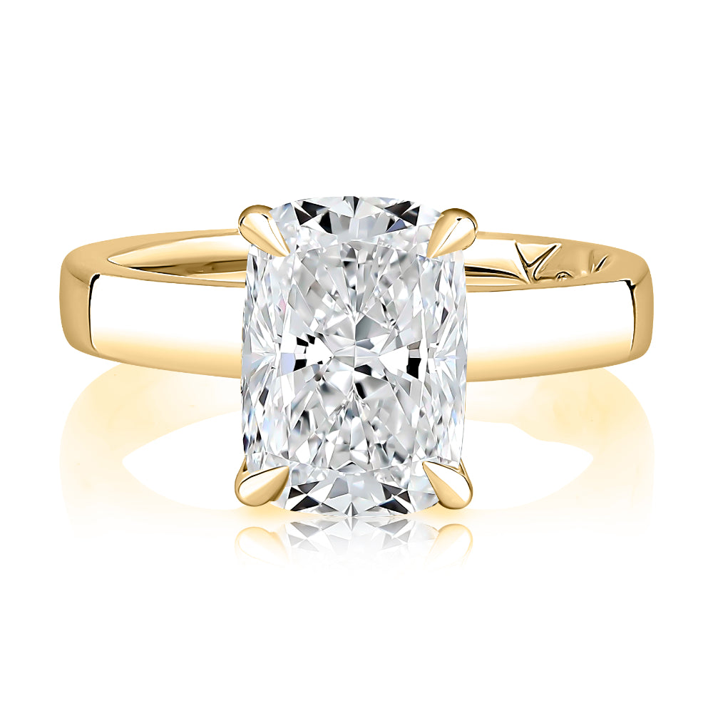 Gold ring with a large diamond on a white background