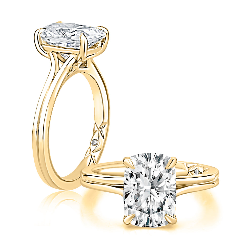Gold ring with a large diamond and a smaller diamond on a white background