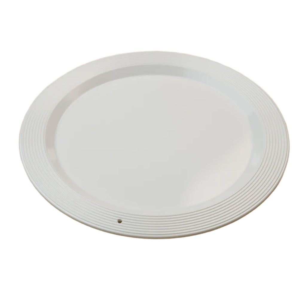 A side photo of a white ceramic plate with decorative rim on a white background