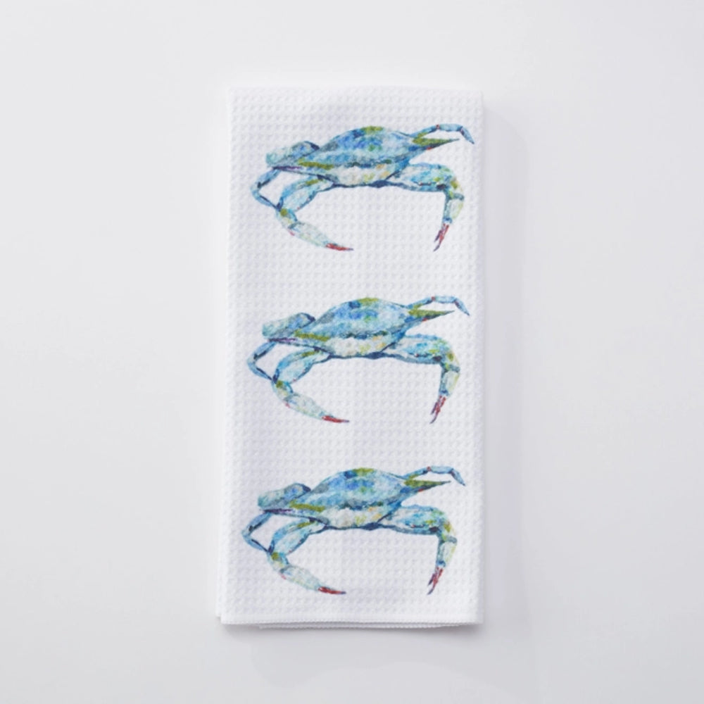 White towel with blue crab designs on a white background