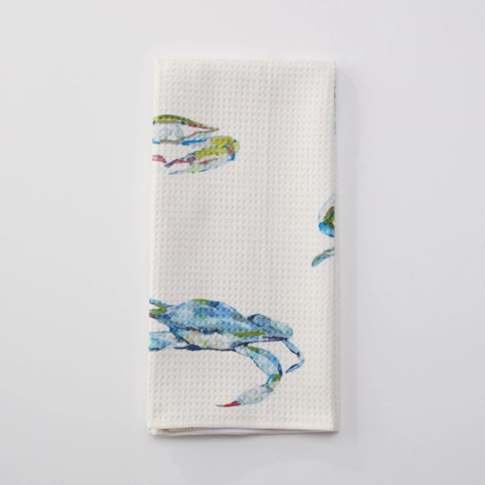 White towel with colorful crab design on a light gray background