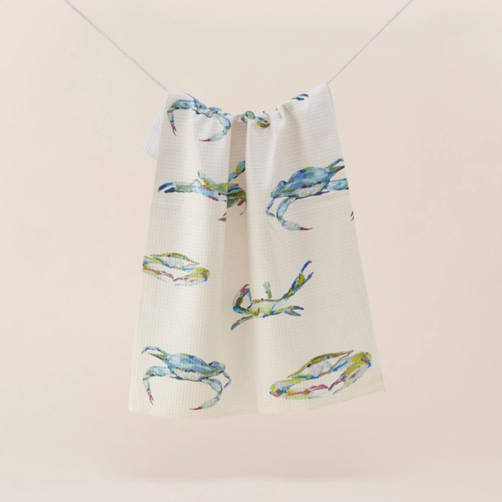 Towel with blue crab design on a beige background