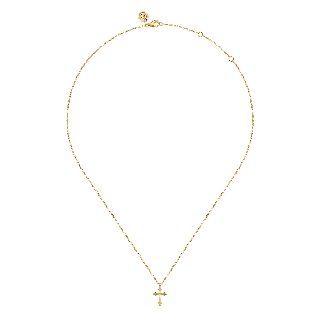gold cross pendant necklace on white background