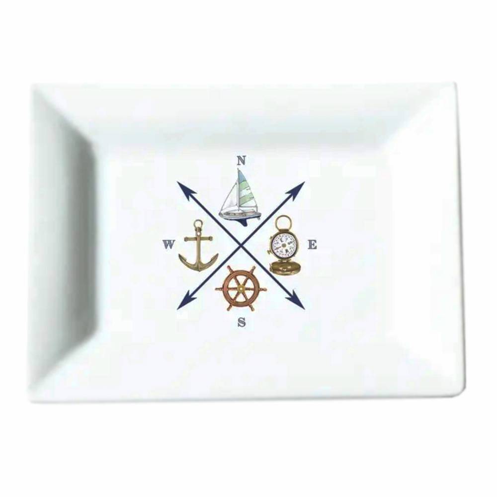 A white rectangular ceramic tray with rounded corners, featuring a central nautical compass design with a sailboat, anchor, compass rose, ship's wheel, and cardinal directions.