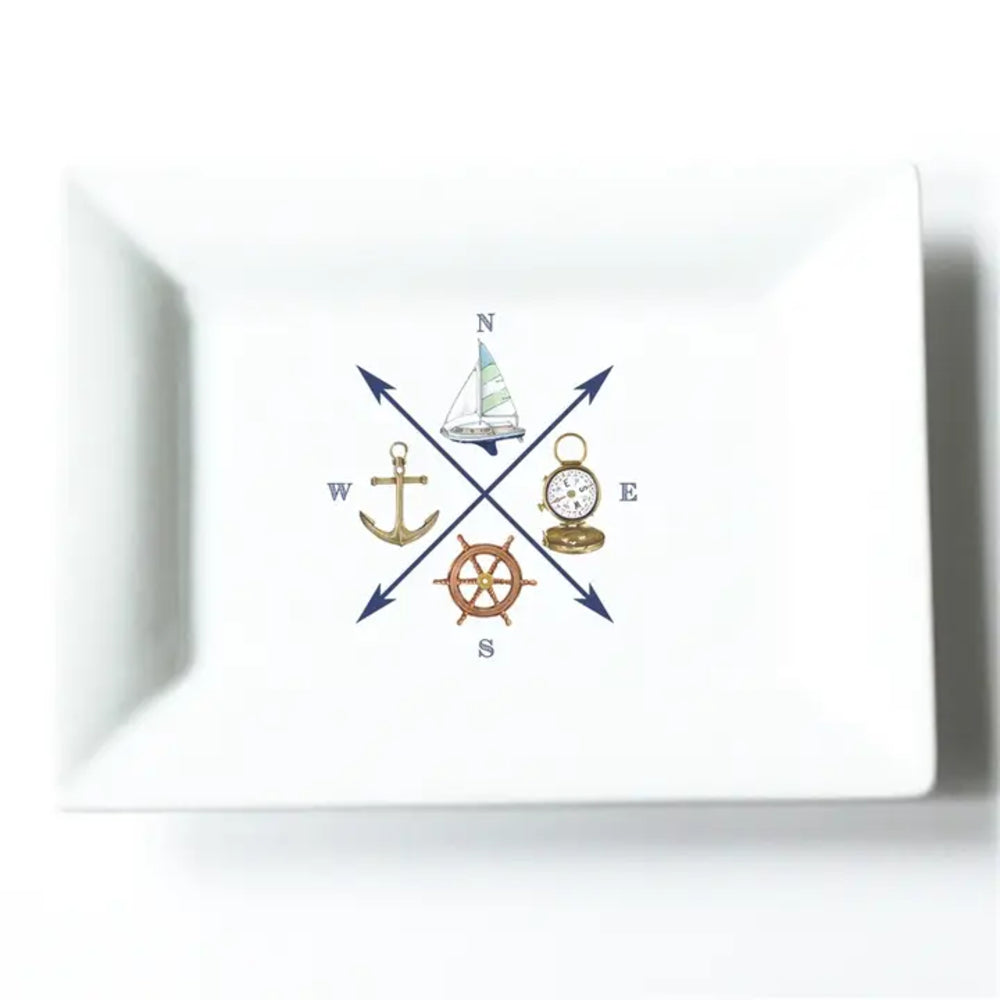 A white rectangular ceramic tray with rounded corners, featuring a central nautical compass design with a sailboat, anchor, compass rose, ship's wheel, and cardinal directions.
