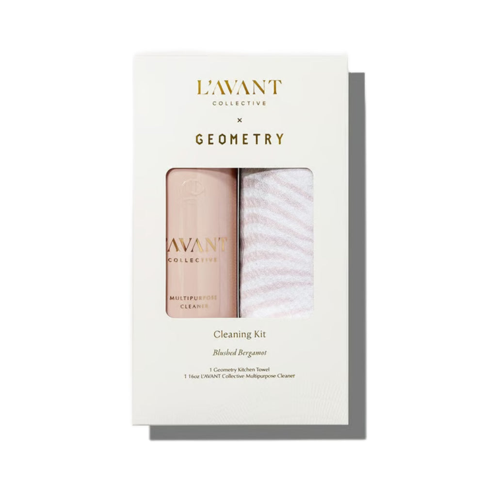 L'Avant Collective x Geometry Cleaning Kit in a white box with a window showing a pale pink cleanser bottle and a white striped towel.