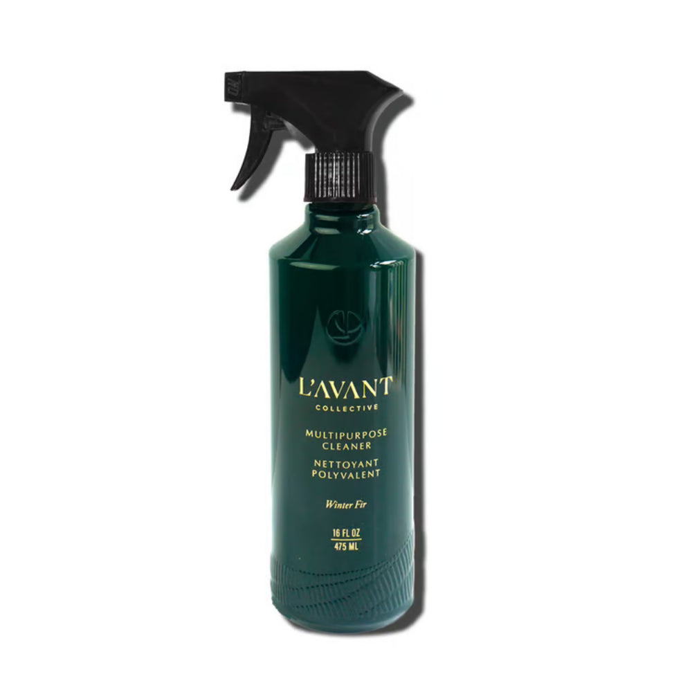 A dark green spray bottle of L'Avant Collective Multipurpose Cleaner with a black trigger sprayer, set against a plain white background with a soft drop shadow.