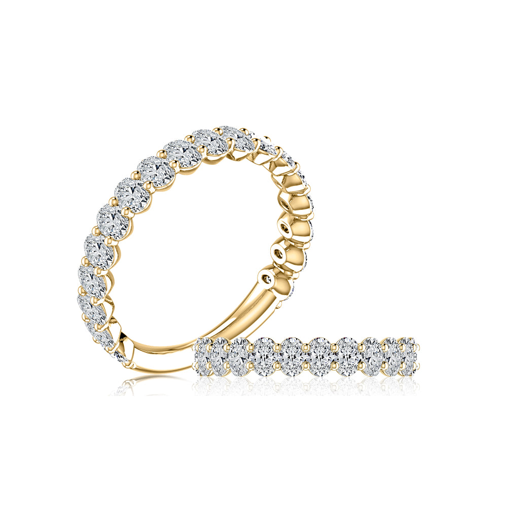 gold rings with clear stones from different angles on white background