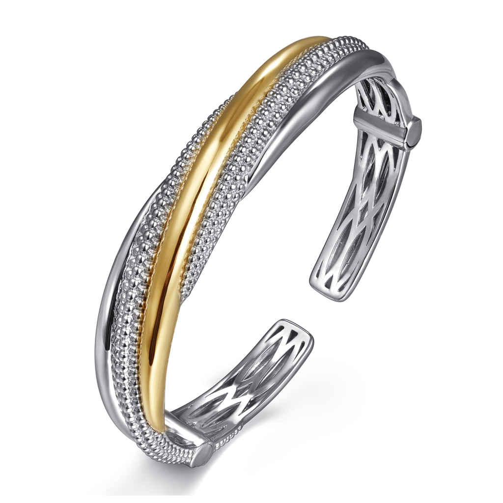 Two-tone silver and gold bracelet on a white background