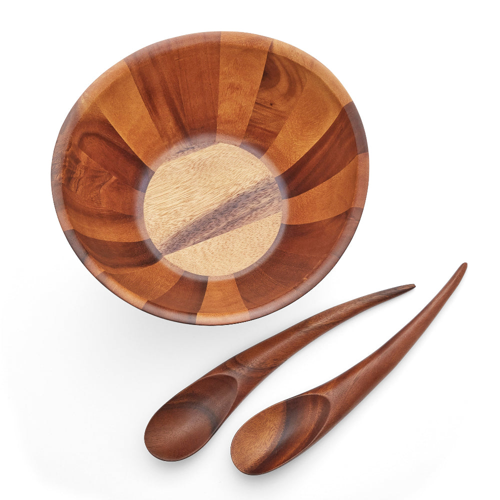 A photo looking into the top of a bowl  and two wooden spoons next to it  on a white background