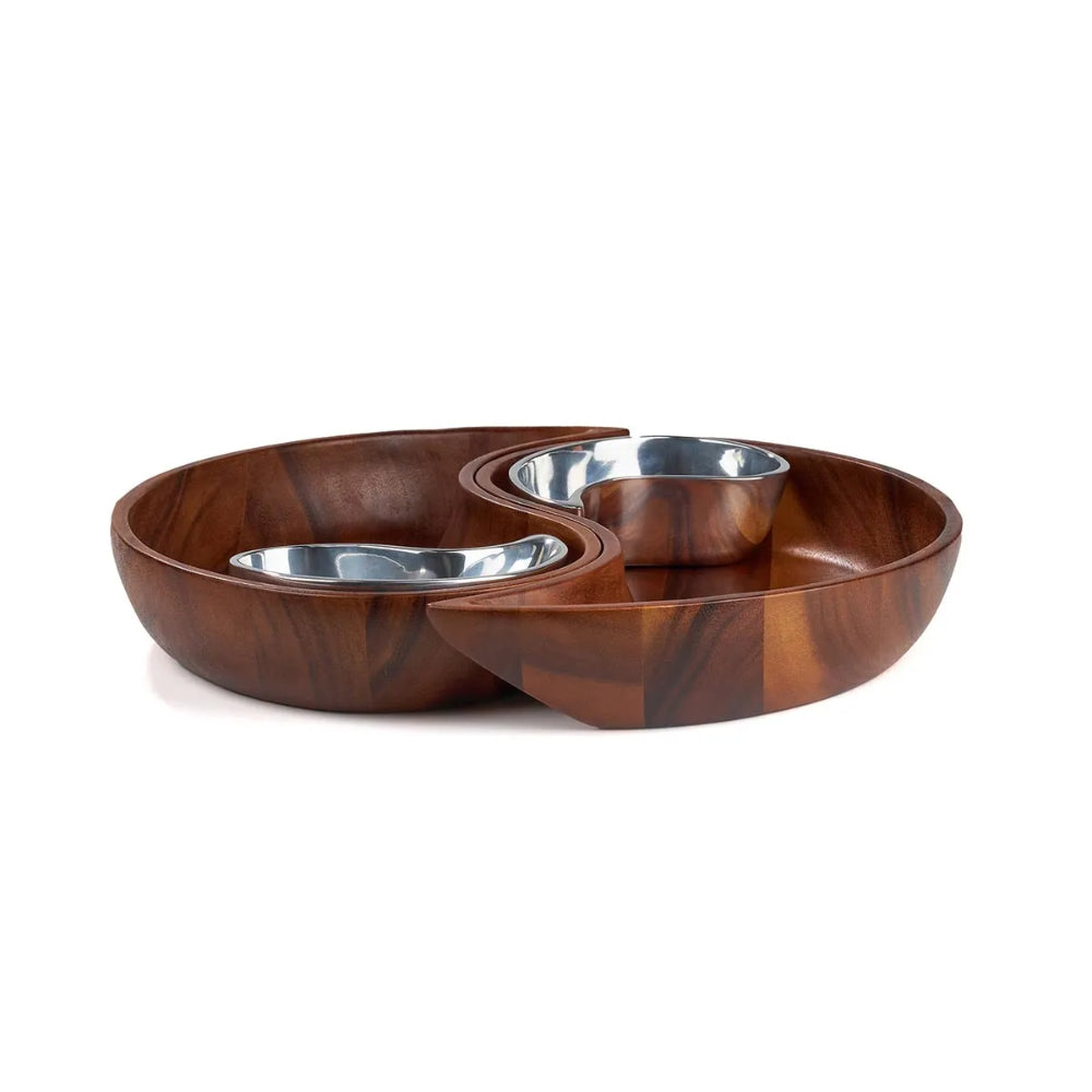 Side photo of the brown wooden yin yang chip dip bowl set with with silver metal bowls on a white background