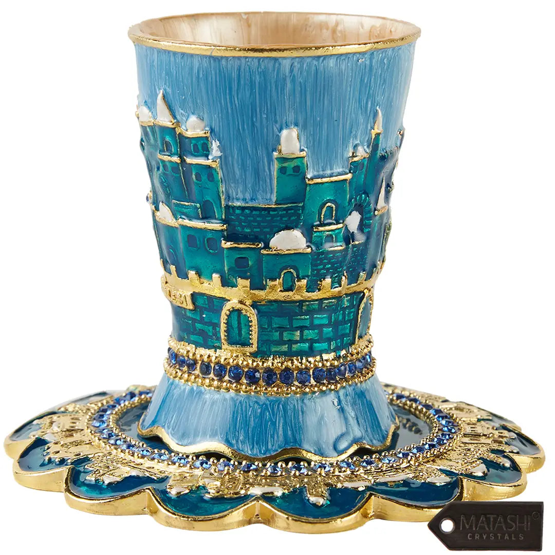 Decorative blue and gold cup with castle design on a white background