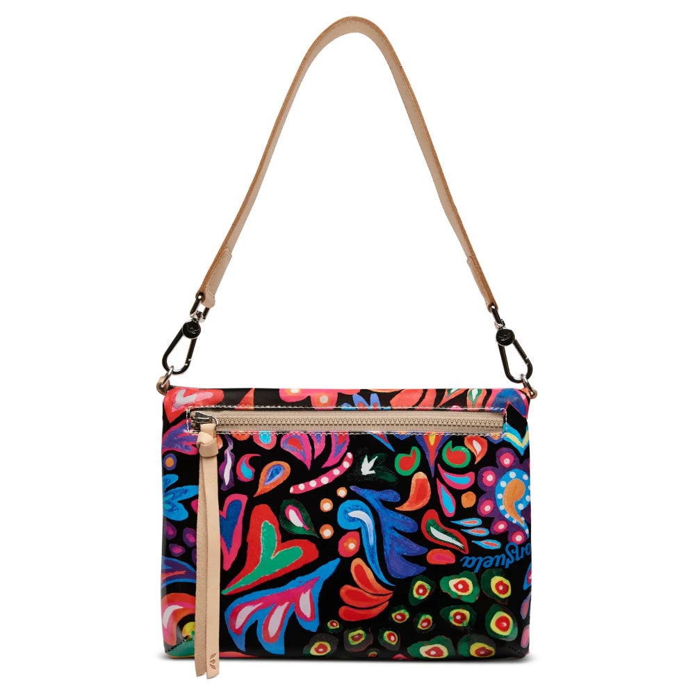 Colorful patterned handbag with a tan strap on a white background