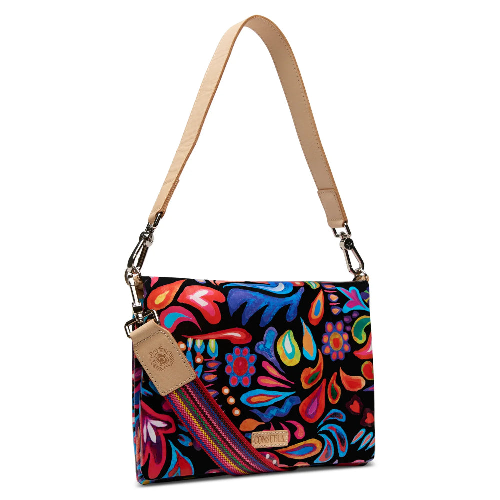 Colorful patterned handbag with a beige strap on a white background