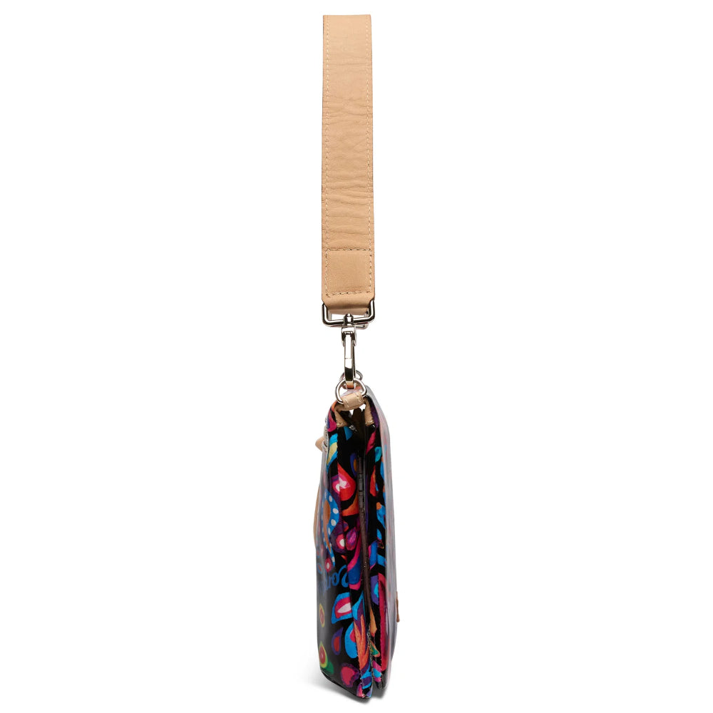 Colorful bag with a floral pattern on a beige strap against a white background