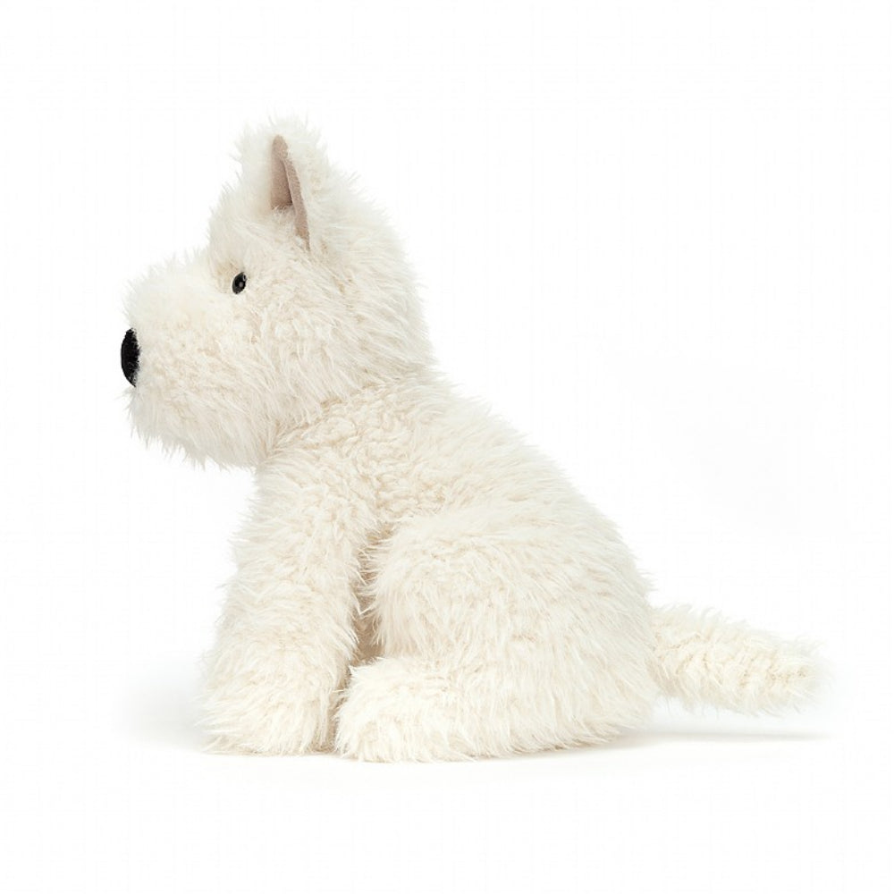 An side photo of a white plush dog toy on a white background