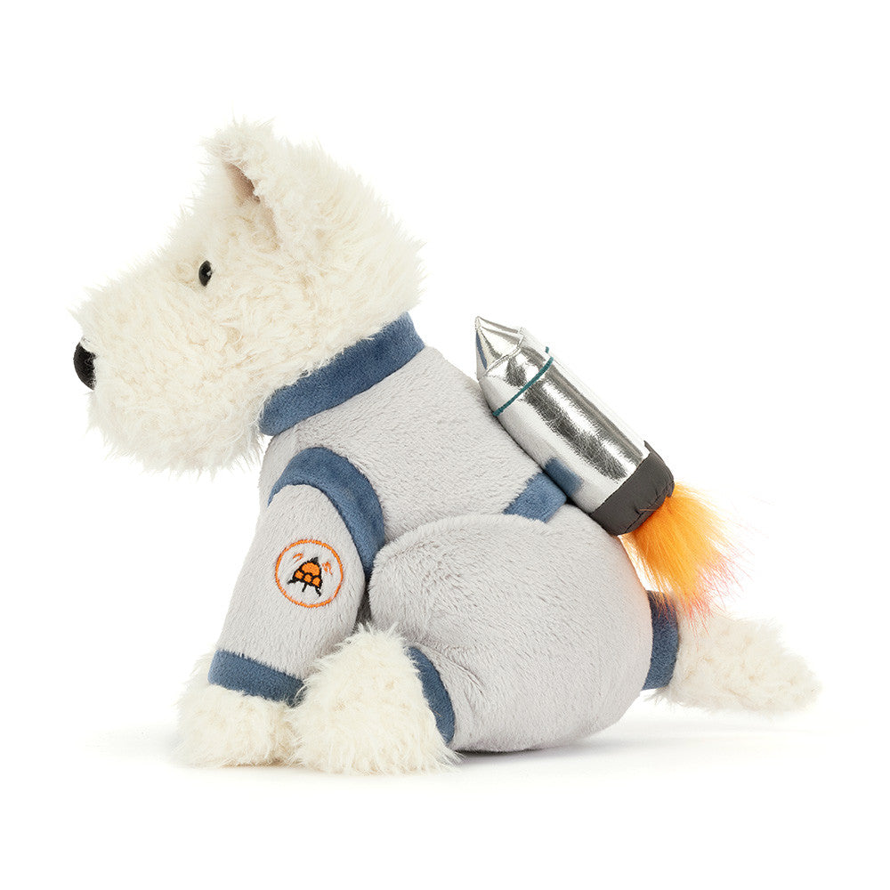 A side photo a white  plush dog toy with a space-themed design outfit on a white background.