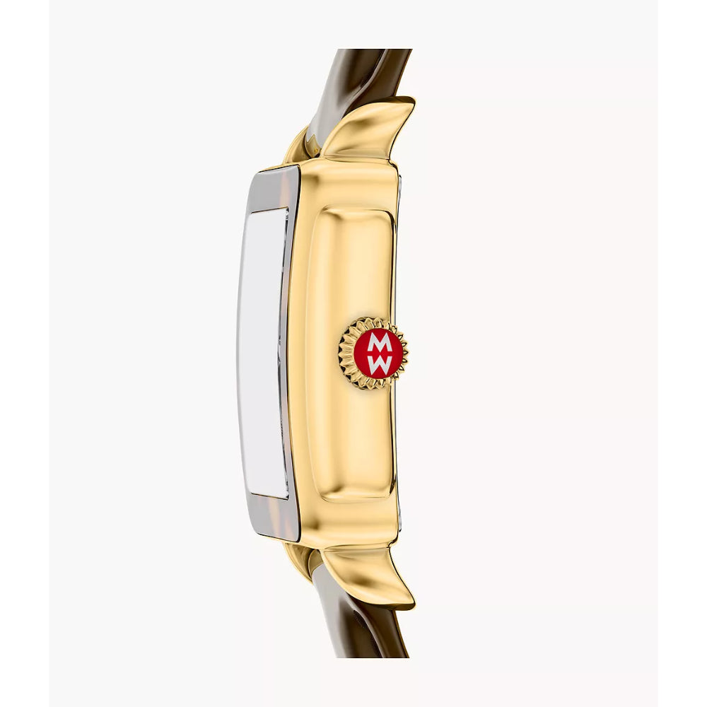 A close-up side view of a gold-tone watch case with a brown strap, featuring a red circular 'MW' logo on the side.