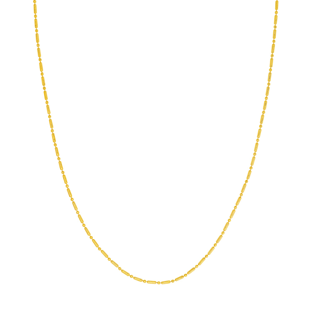 gold tone necklace on white background