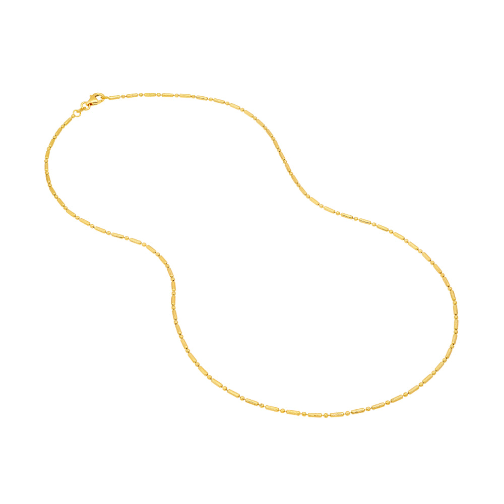 gold tone necklace flat on white background