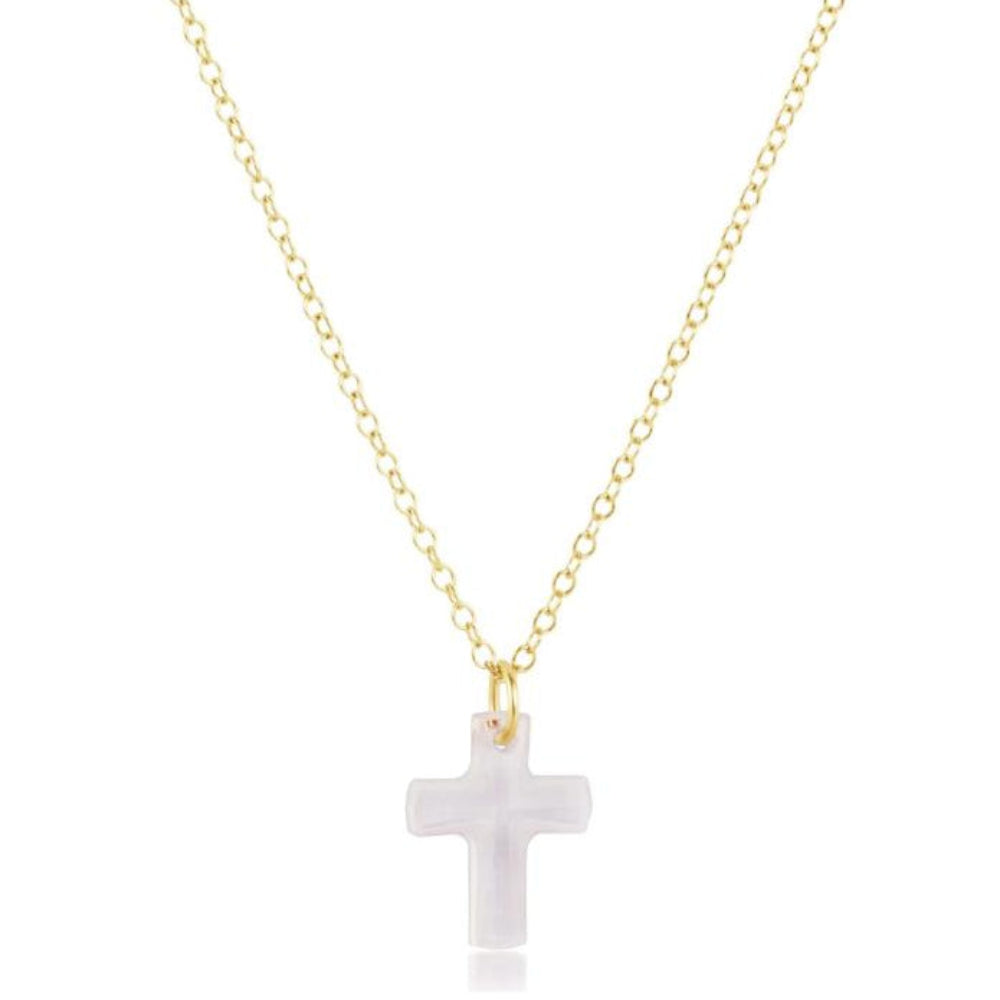 Gold necklace with a white cross pendant on a white background
