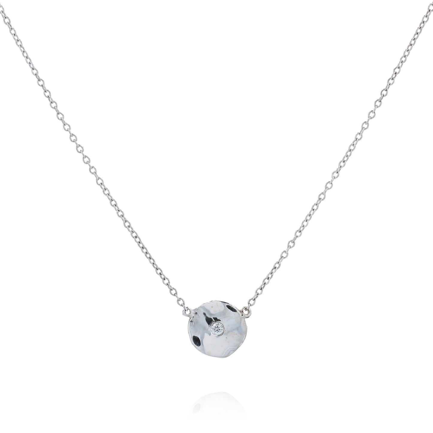 White gold wavy disc design diamond pendant necklace on a white background
