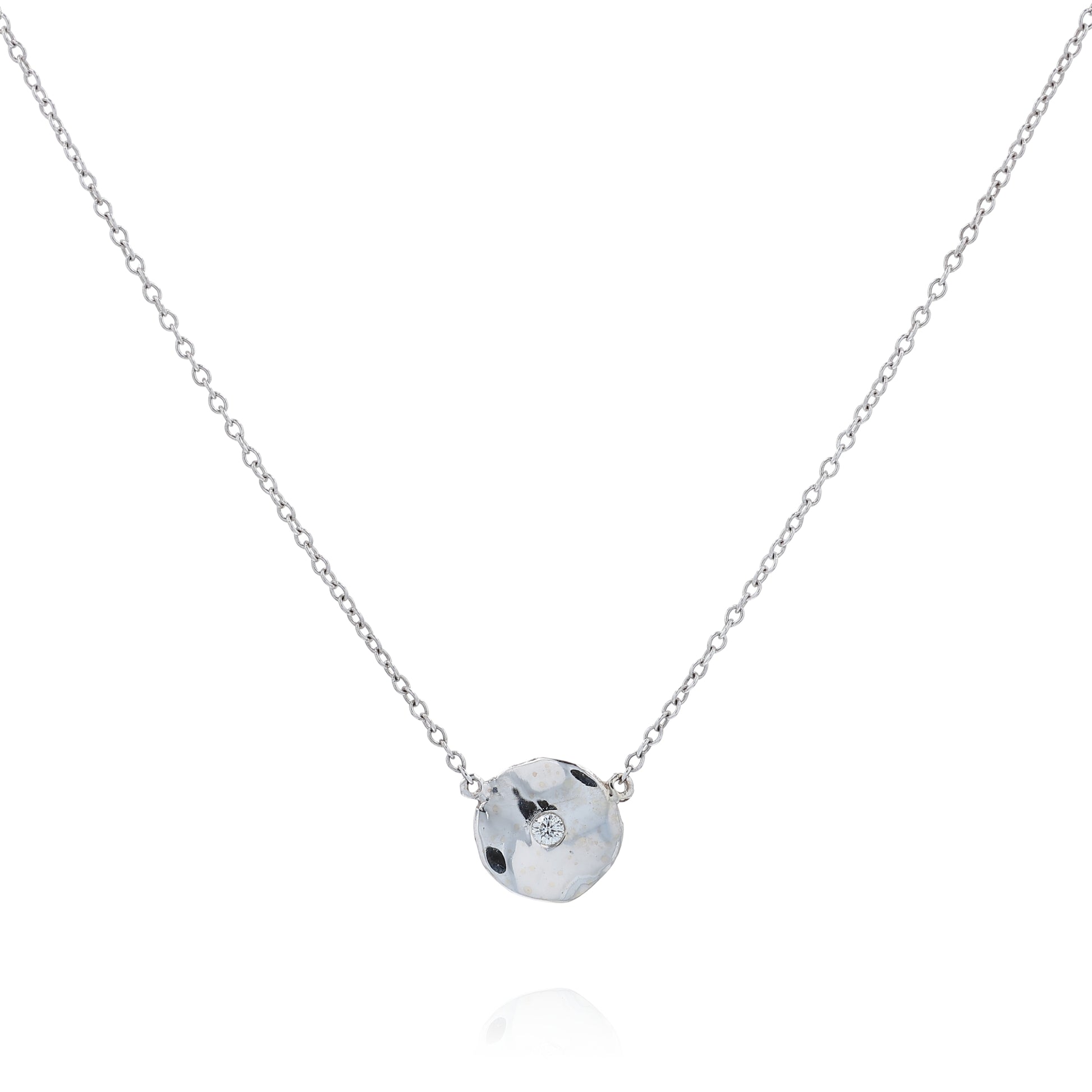 White gold wavy disc design diamond pendant necklace on a white background