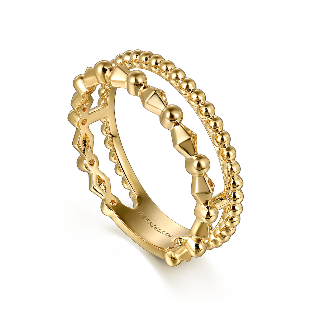 Gold ring with geometric design on a white background