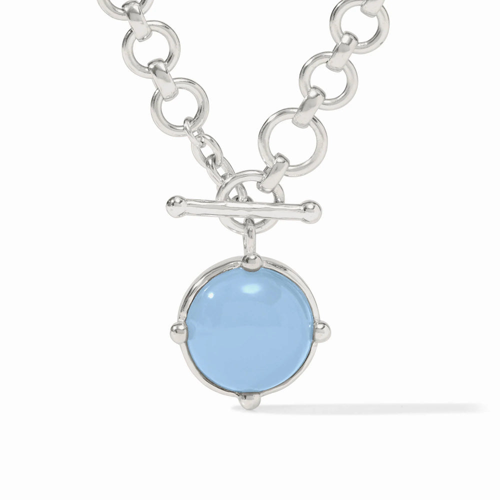 Silver necklace with a blue pendant on a white background