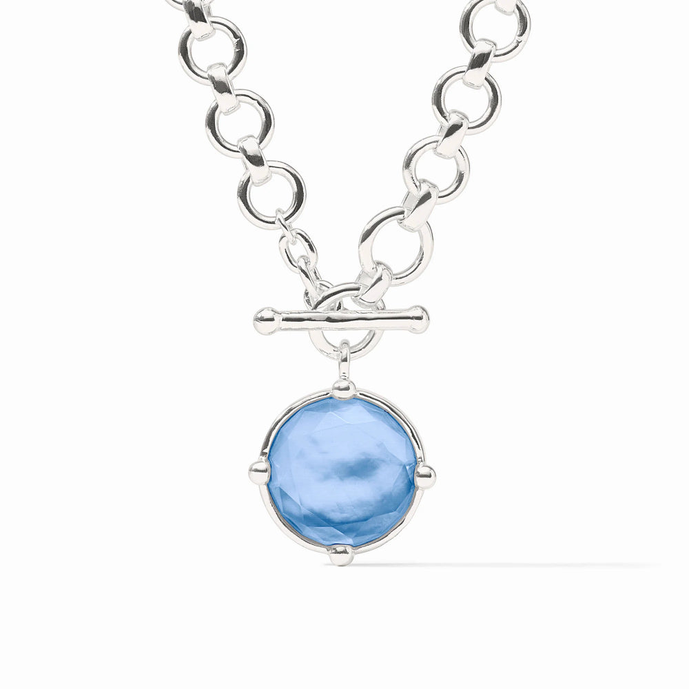 Silver necklace with a blue pendant on a white background