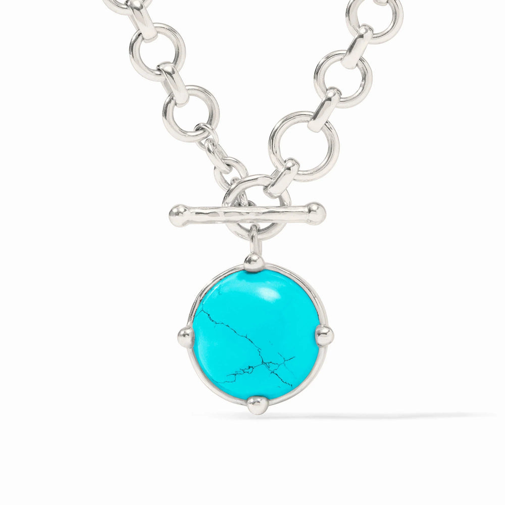 Silver necklace with a turquoise pendant on a white background