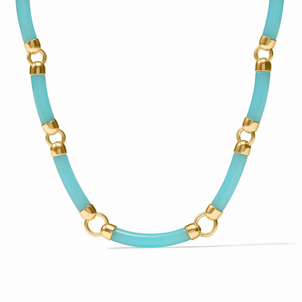 Necklace with turquoise beads and gold accents on a white background