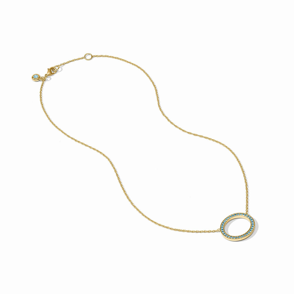 A delicate gold chain necklace featuring a large open oval pendant encrusted with small blue stones, displayed on a clean white background.