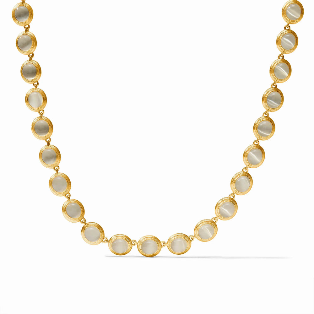 Gold necklace with circular beads on a white background